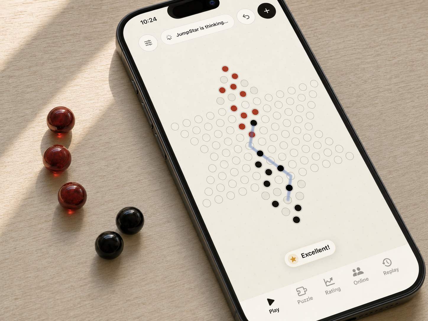 JumpStar Chinese Checkers running on iPhone beside red and black glass game pieces